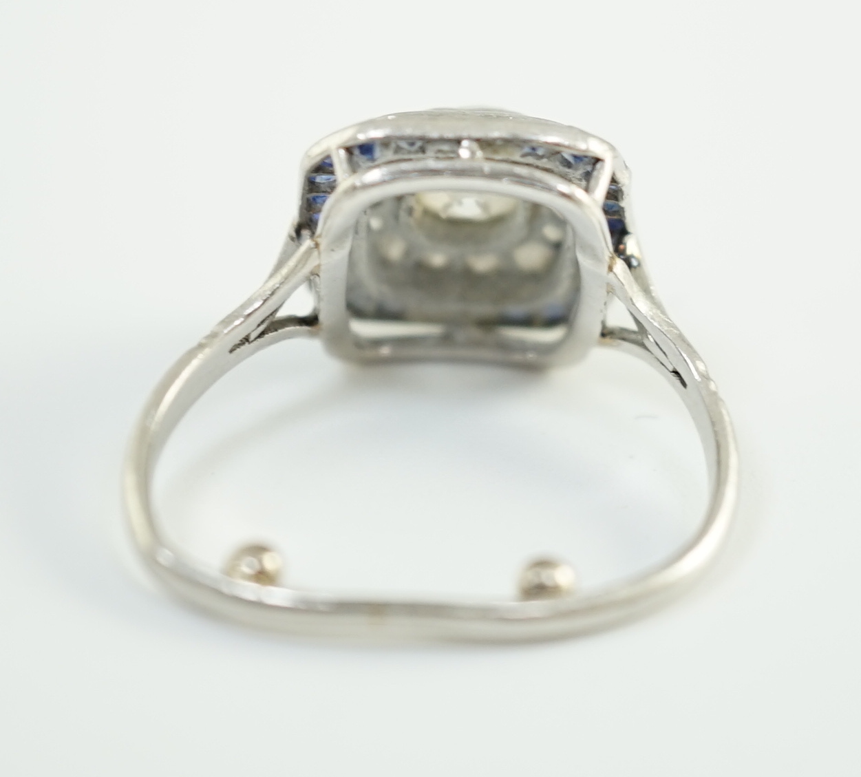 An Art Deco platinum, diamond and sapphire set rectangular cluster ring